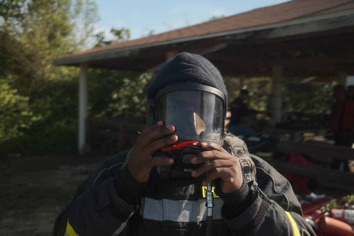 A firefighter checking a breathing apparatus mask