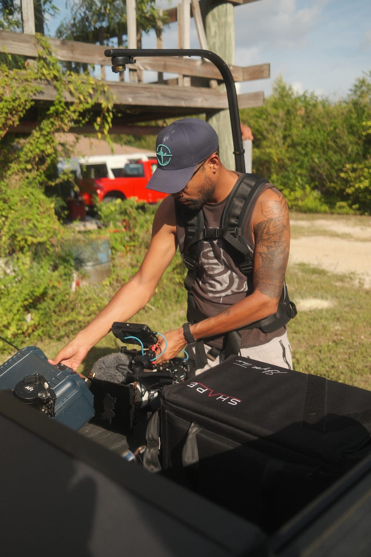 An operator carrying a gimbal rig on a fire service exercise ground