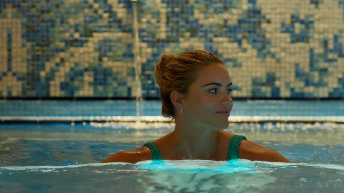 A swimmer in a blue tiled pool